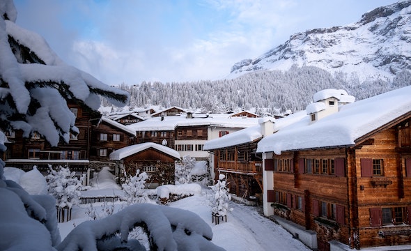 Cozy chalet at dusk with snowy peaks